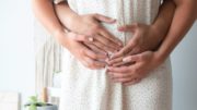 Early pregnancy symptoms - a man holding his hands on a woman's belly