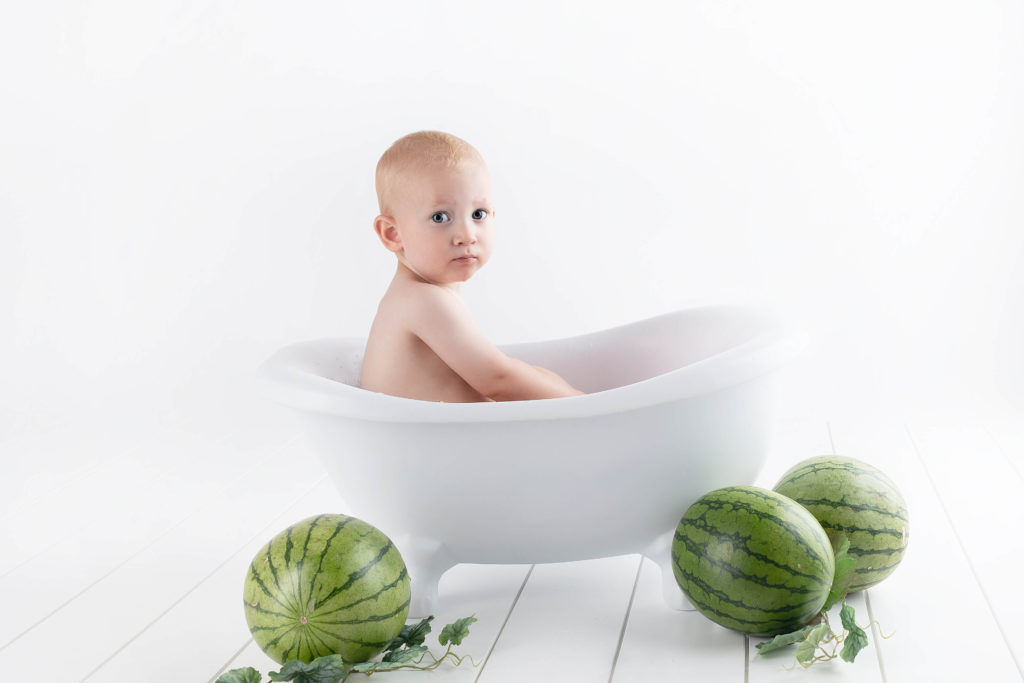 Pregnancy, week by week - baby sitting in a tub surrounded with watermelons