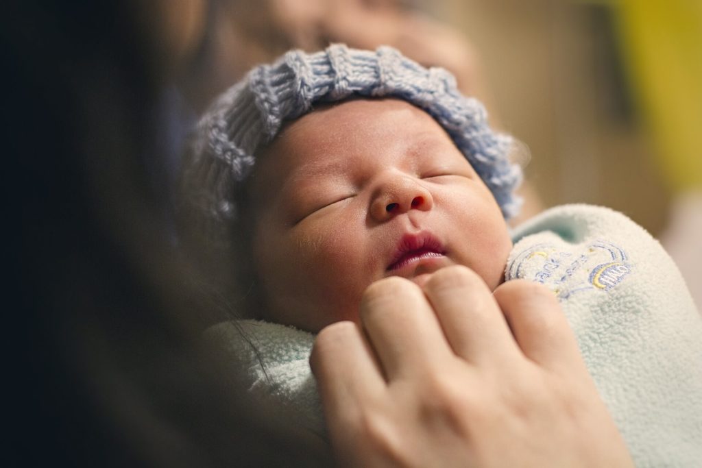 caring for a newborn - newborn in woman's arms
