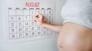 Pregnancy, week by week - pregnant woman next to a calendar
